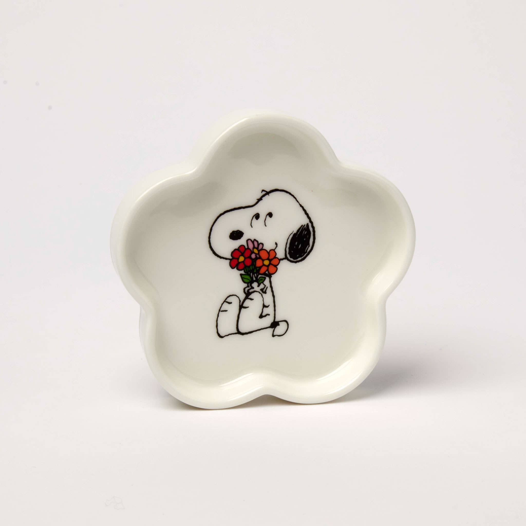 Flower-shaped ceramic trinket dish featuring a black-and-white beagle holding a bouquet of red and orange flowers, packaged in a pink and green gift box.