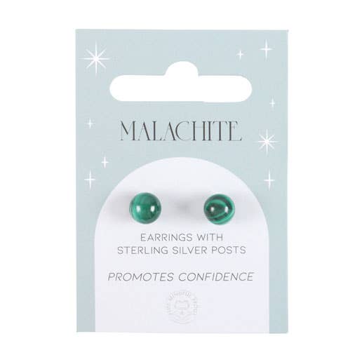 Hand holding a pair of malachite crystal stud earrings on a matching backing card with the text “Promotes Confidence.”