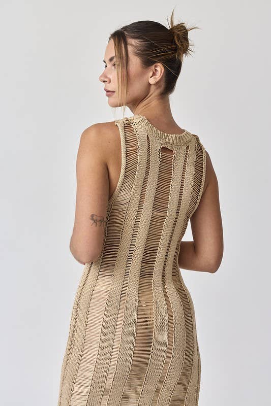 Woman wearing a sleeveless ladder knit midi dress.