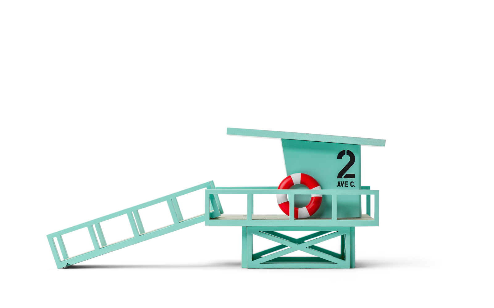 Toy lifeguard stand with a red life buoy on a white background