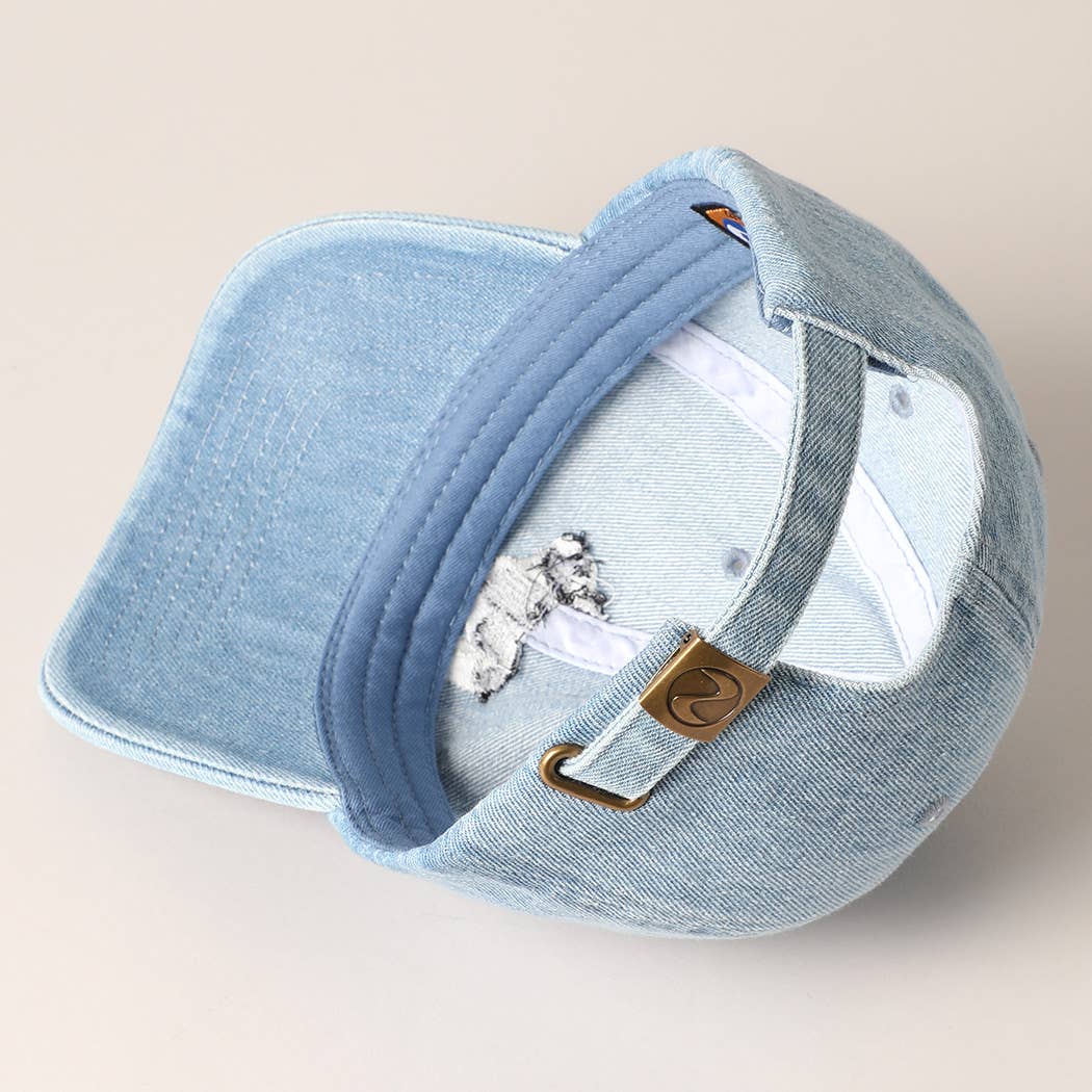 Light-wash denim baseball cap with embroidered black and white French Bulldog design.