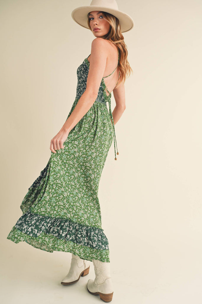 Panoramic view of the enchanting Deeane Ruffle Dress in vibrant green with floral pattern.