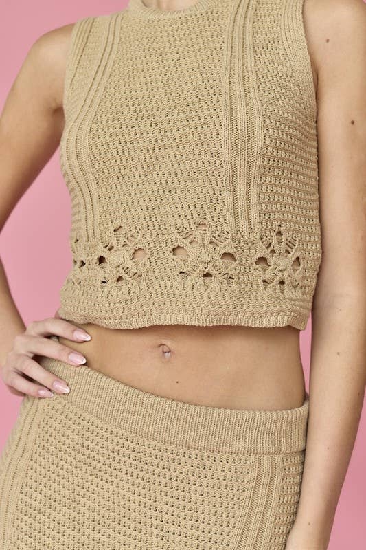 Woman wearing a beige sleeveless crochet top and midi skirt set.