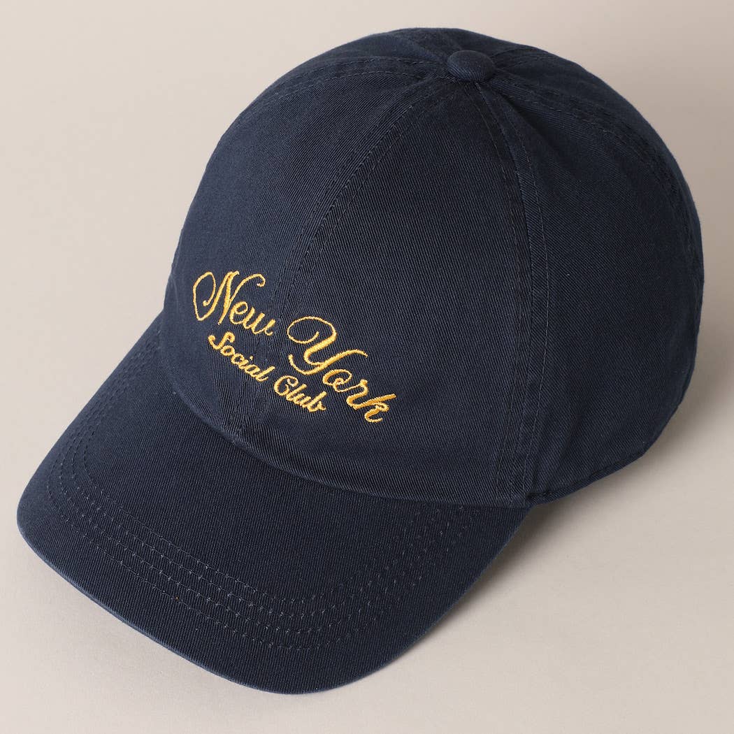 Beige and navy New York Social Club embroidered baseball caps with curved brims.