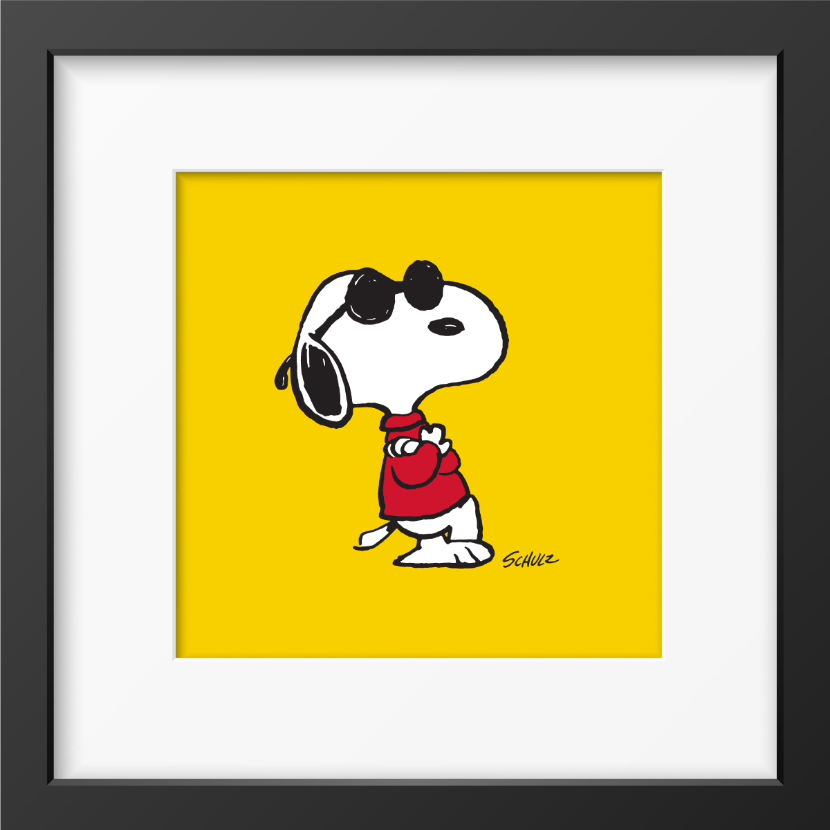 Framed artwork of Snoopy wearing sunglasses and a red sweater, set against a bright yellow background with a black frame.