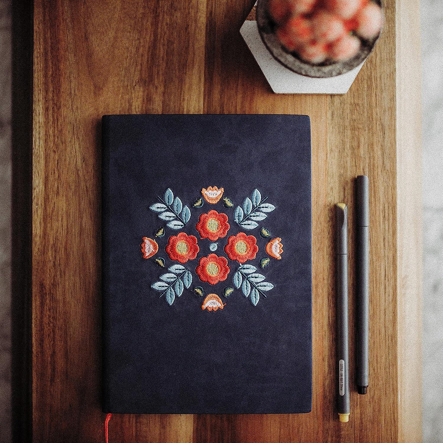 Floral Embroidered Notebook - A luxurious notebook with intricate floral embroidery, perfect for capturing your thoughts and ideas.