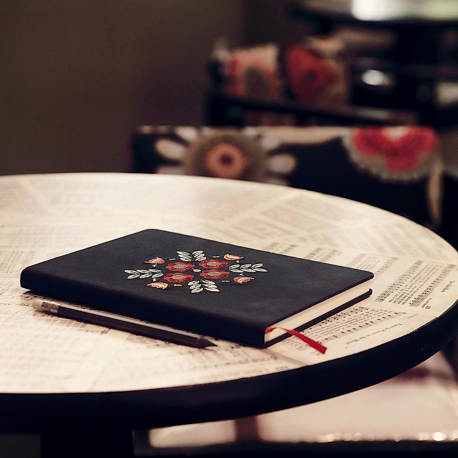 Floral Embroidered Notebook - A luxurious notebook with intricate floral embroidery, perfect for capturing your thoughts and ideas.