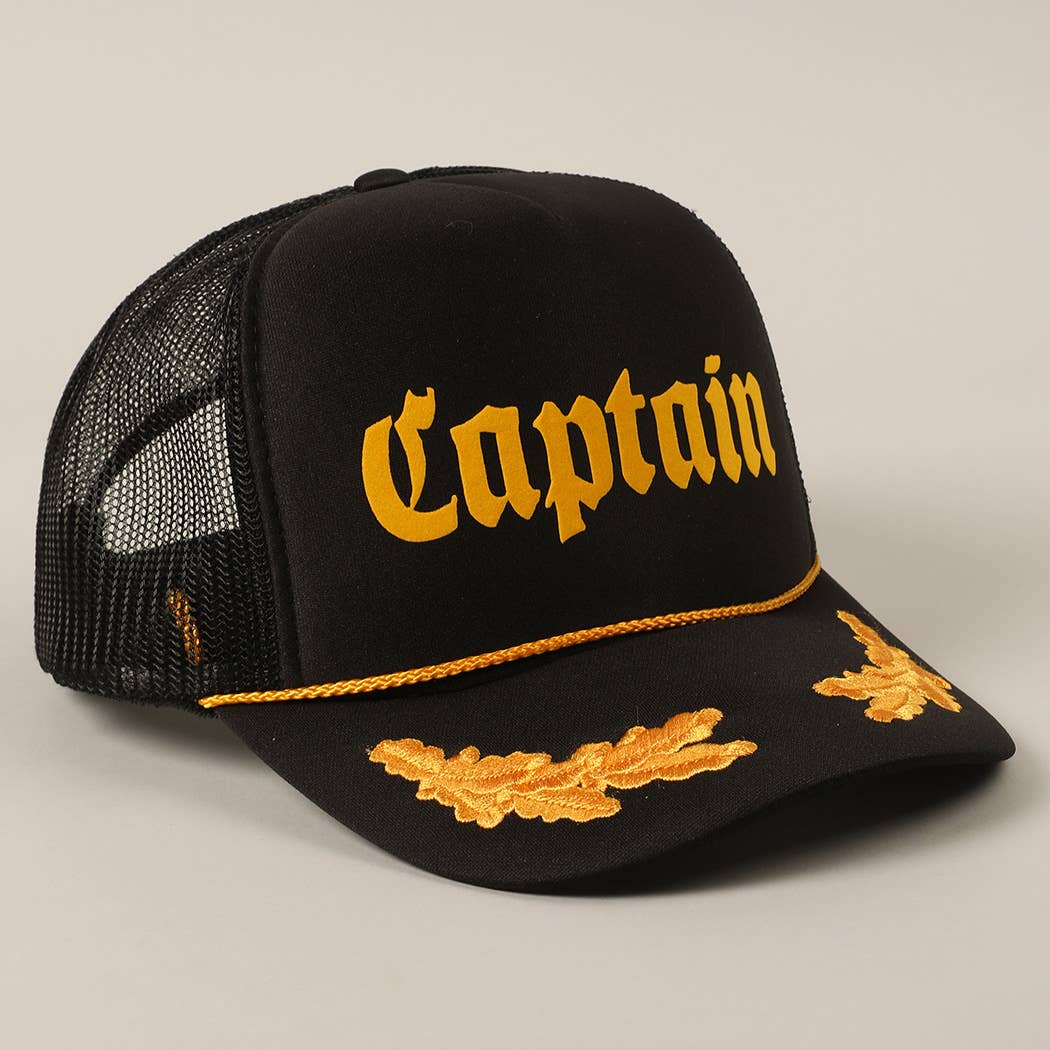 Black cap with yellow 'Captain' text and embroidered details on a neutral background