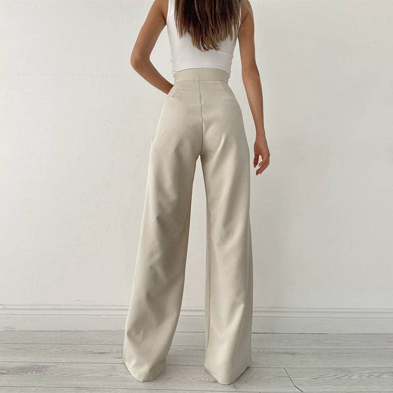 Woman wearing Urban Elegance Palazzo Pants in cream color with a white crop top.