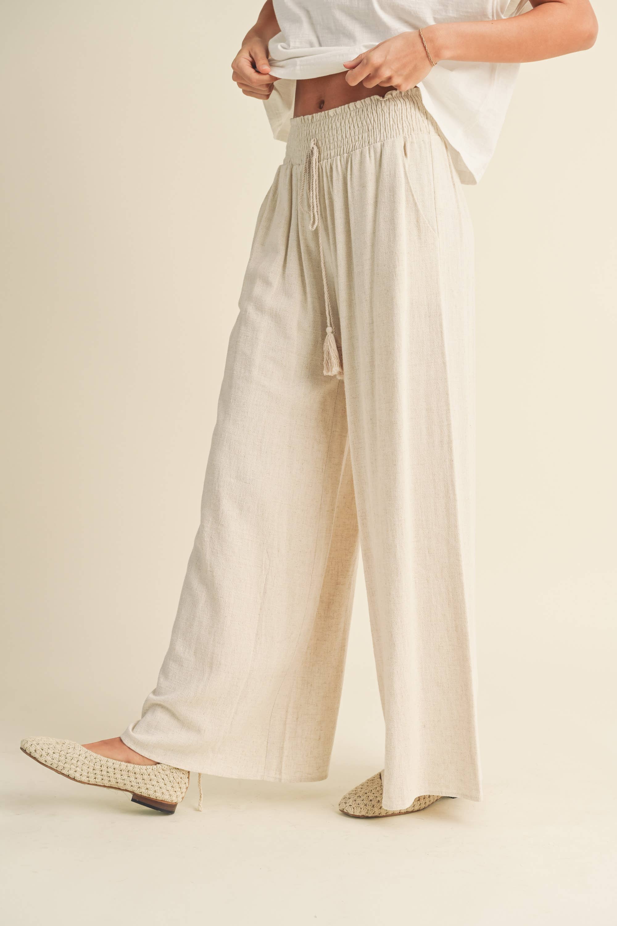 Wide-leg cotton-linen pants with smocked waistband and tassel drawstring
