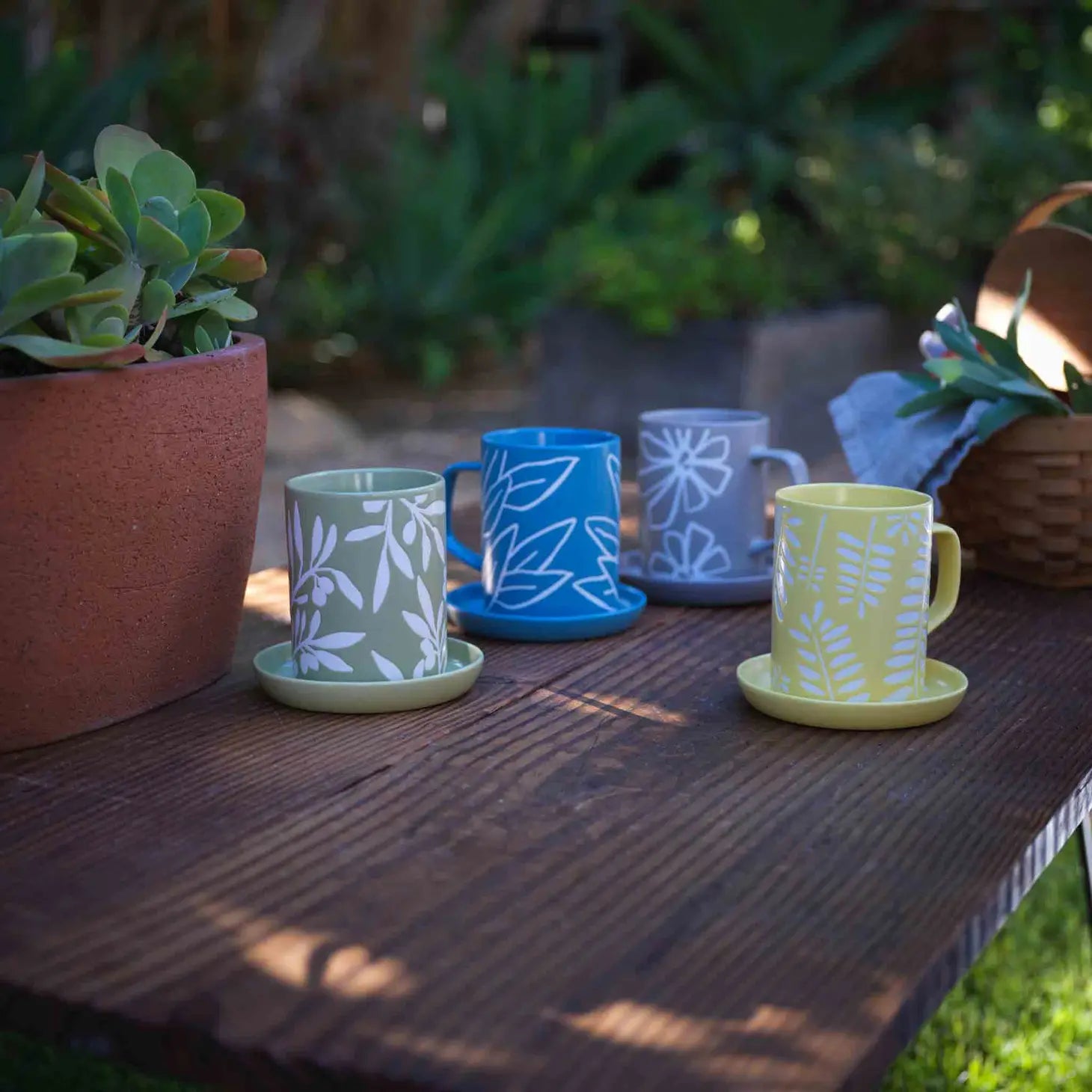 A Ceramic Sage Leaf Mug with a detailed sage leaf pattern, placed on a neutral-toned surface.