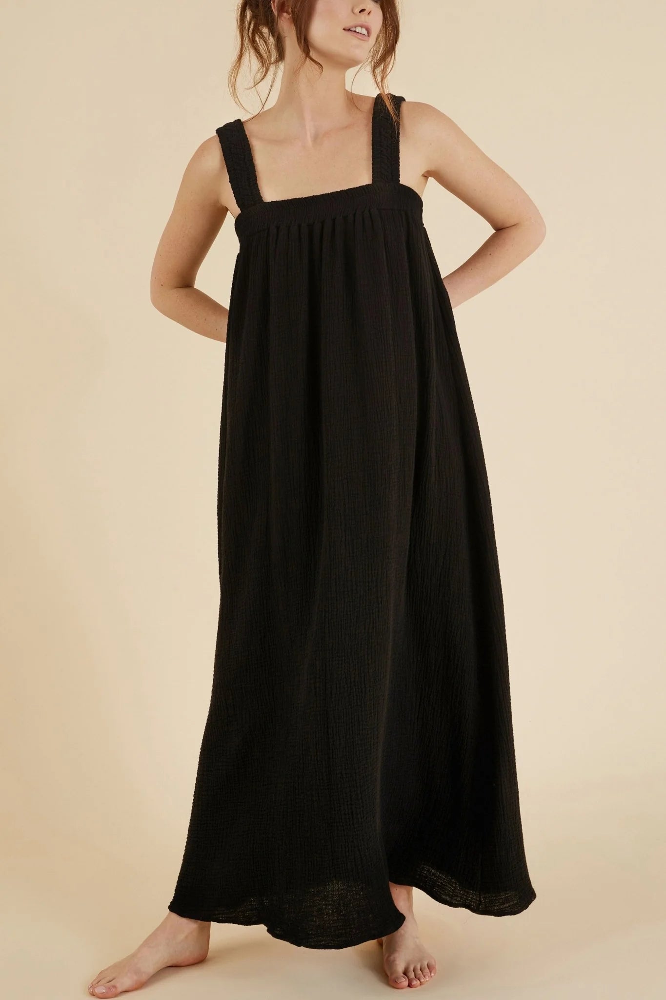 The Noa Straps Maxi Dress, made from 100% Turkish cotton, elegantly displayed, showcasing its delicate straps and flowing maxi length.