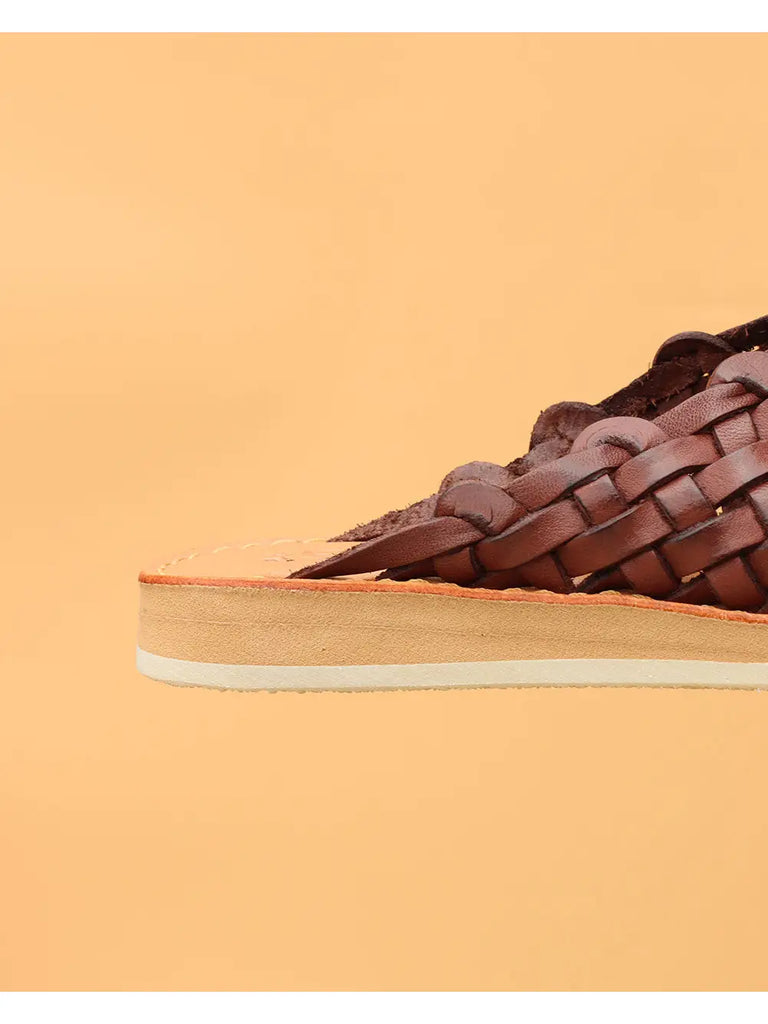 UXMAL sandals, meticulously crafted from 100% premium leather, positioned against a backdrop reflecting Mayan brilliance.