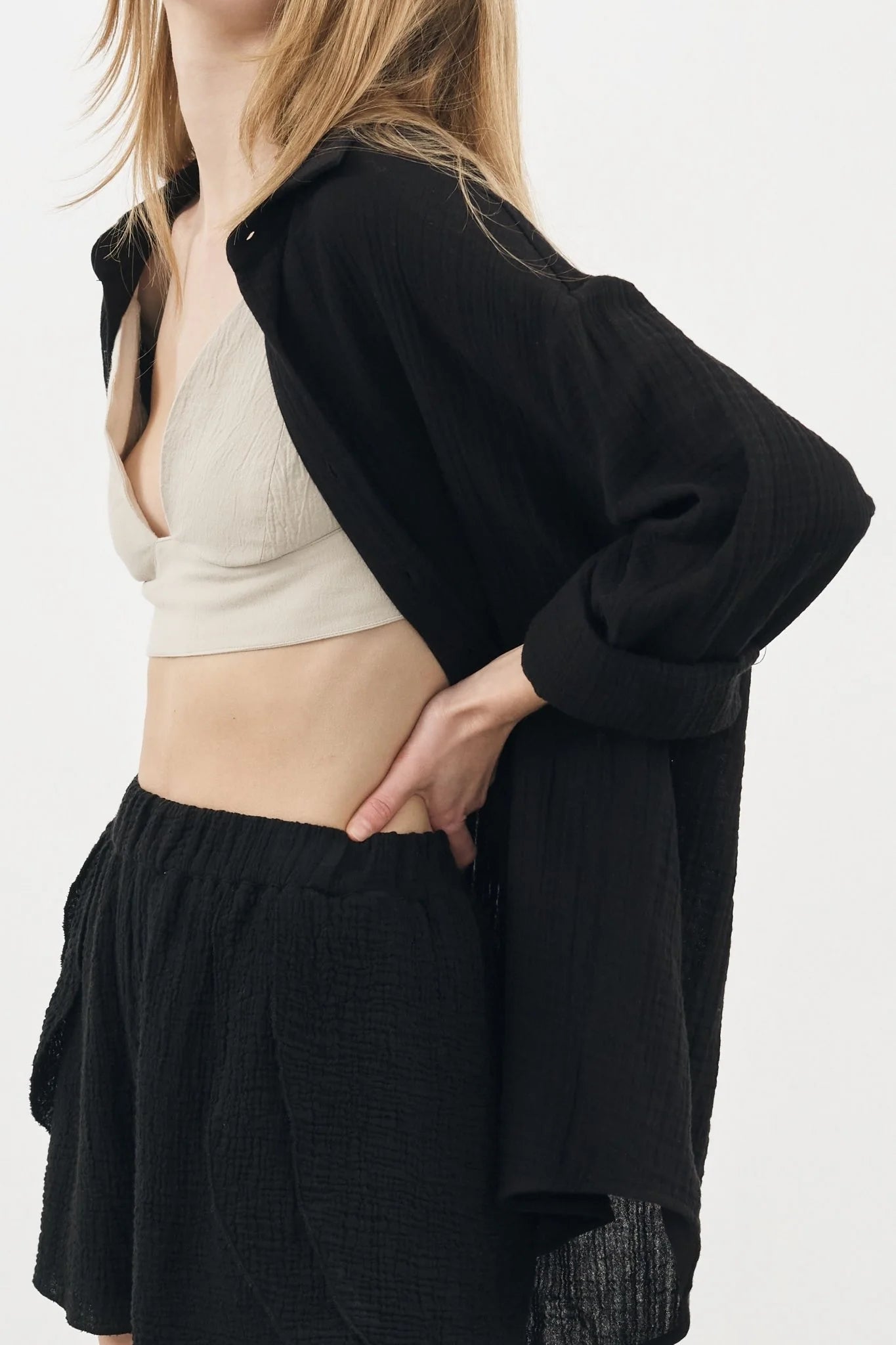 A woman wearing the Sundown Top, showcasing its relaxed fit, short sleeves, and flattering neckline, a versatile and stylish option for any occasion.