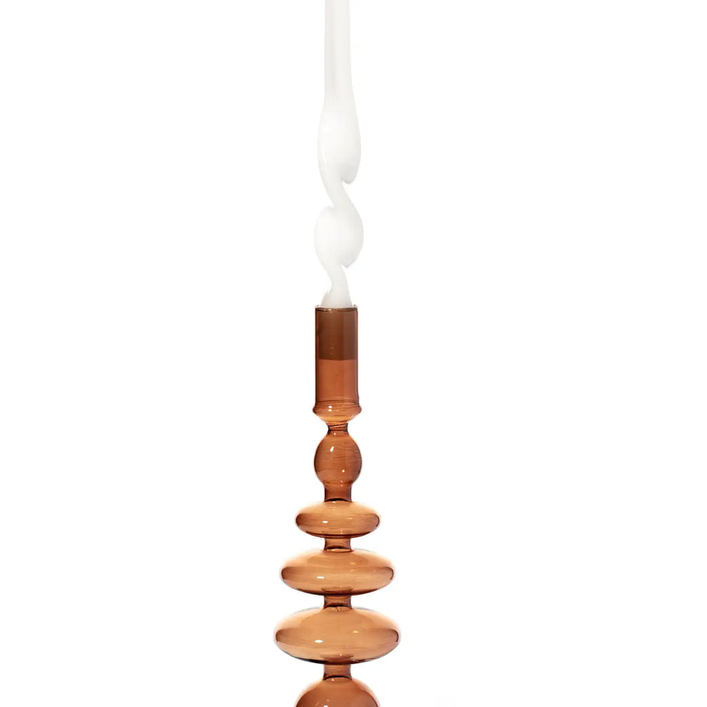 Champagne colored Coloured Glass Taper Holder reflecting a soft, warm light.