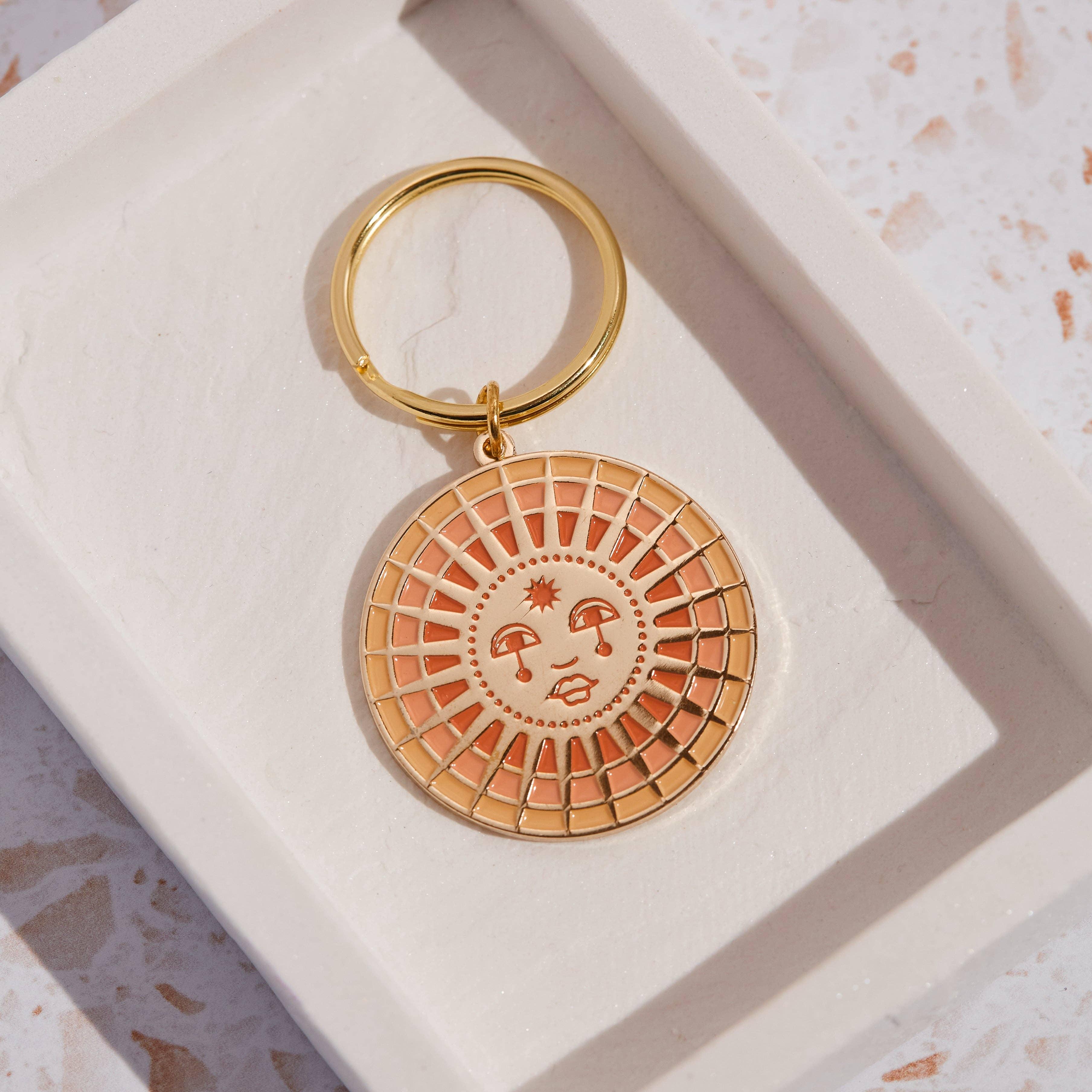 Sun Enamel Keychain showcasing a vibrant sun design with intricate enamel work and a sturdy metal keyring.