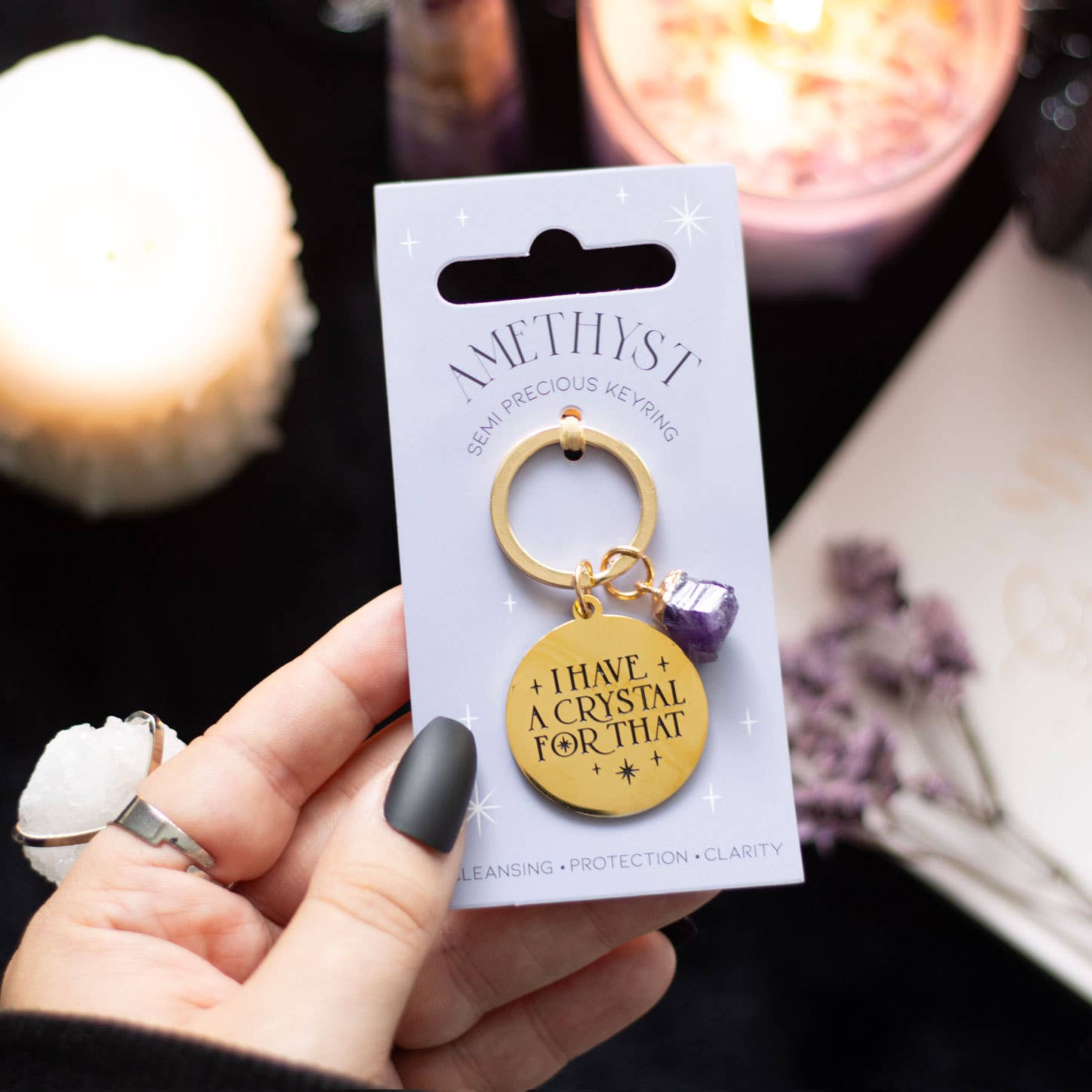 Gold-tone keychain with a medallion engraved “I Have A Crystal For That” and a genuine amethyst crystal charm.