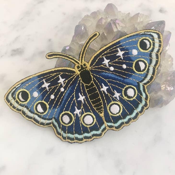 Large embroidered patch showcasing a butterfly in deep navy hues with twinkling star accents.