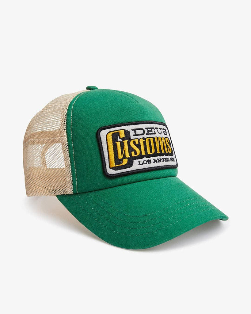 Image of the 'Deus Ex Machina - Stripes Trucker' cap, displaying the front embroidered patch, back embroidered art, and the comfortable cotton canvas and poly mesh fabric.