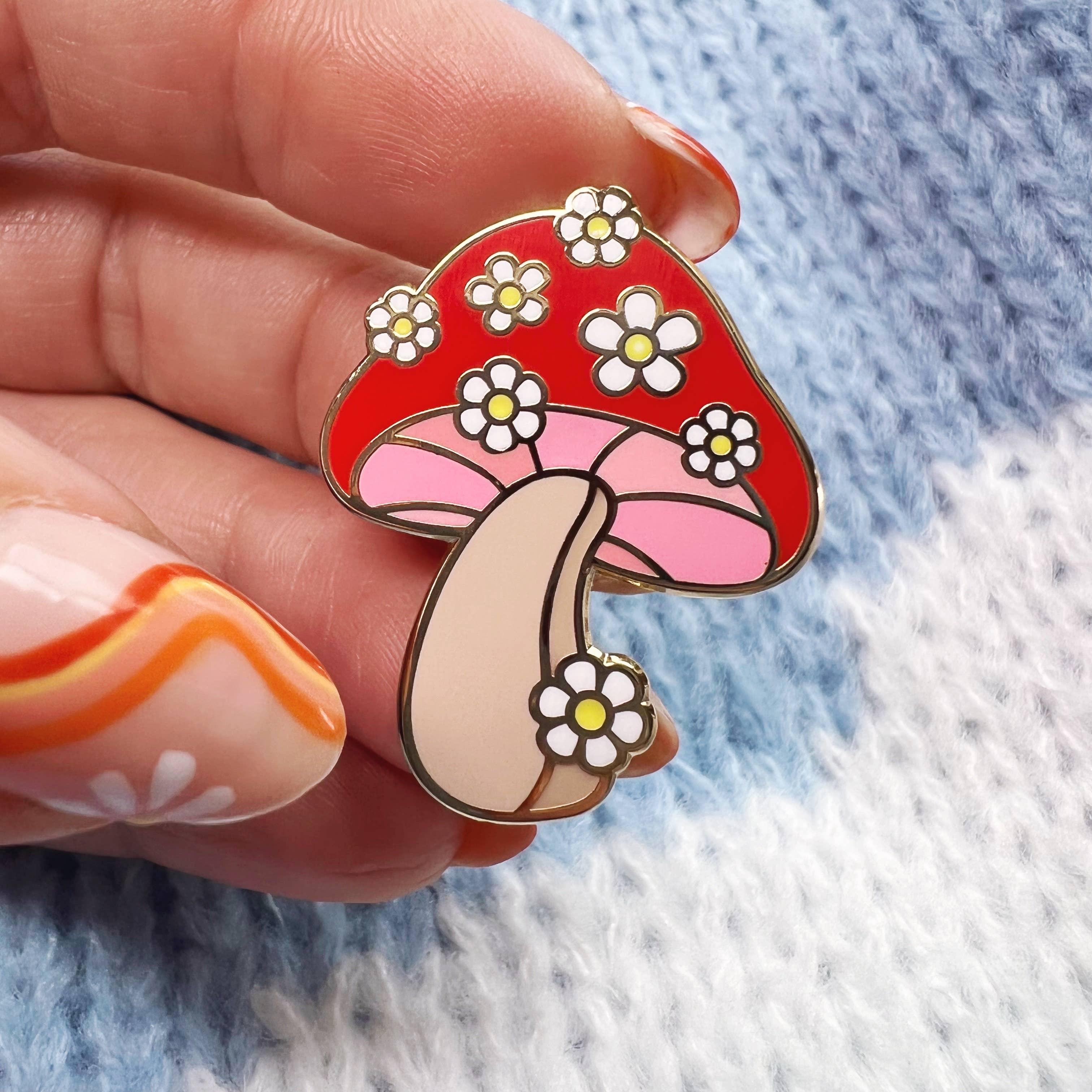 Daisy Mushroom Enamel Pin, featuring a captivating blend of mushroom and daisy design, radiating nature's playful charm.