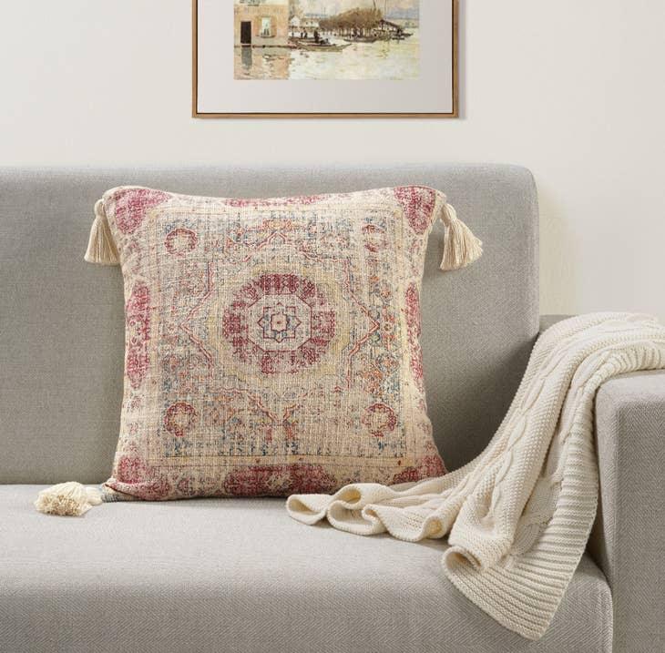Image of the 'Handmade Printed Persian Cotton Pillow Cover', highlighting its soft, fluffy texture, the handmade tassels at each corner, and the intricate printed design.