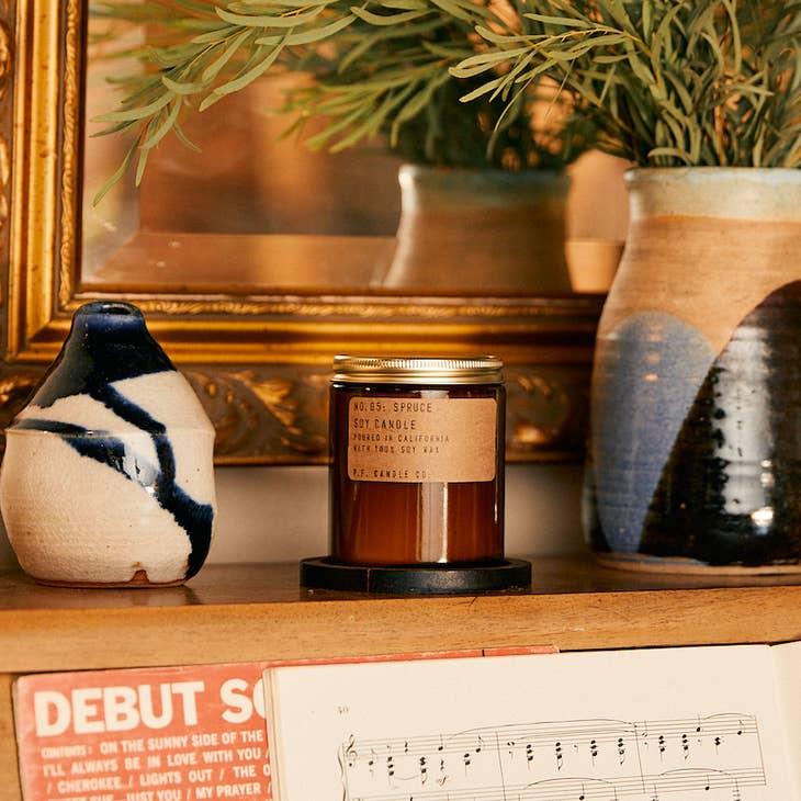 Spruce Soy Candle in sustainable packaging, releasing a fresh, revitalizing spruce forest scent.