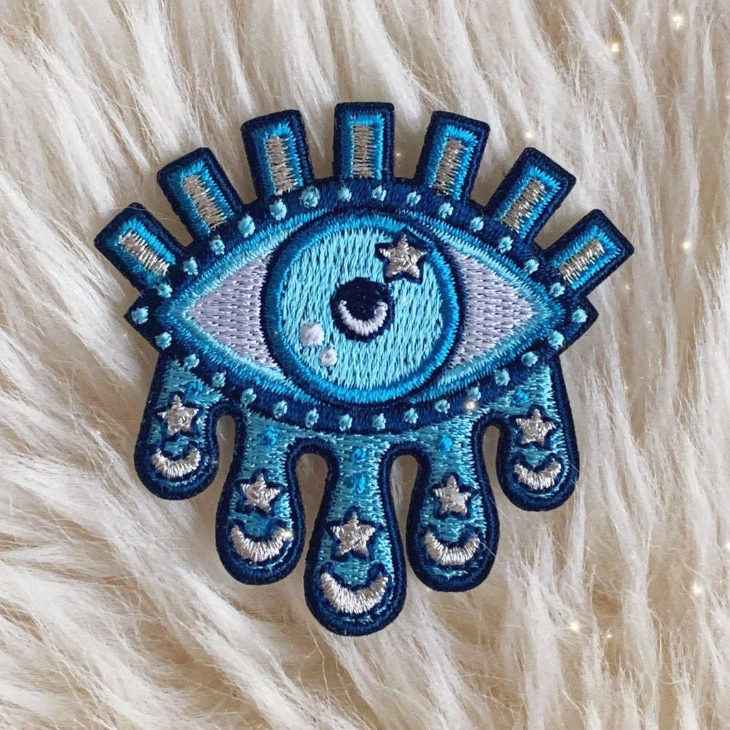 Cosmic Tears Eye Patch, illustrating an eye with tears of cosmic stars and galaxies, symbolizing depth and universe connection.