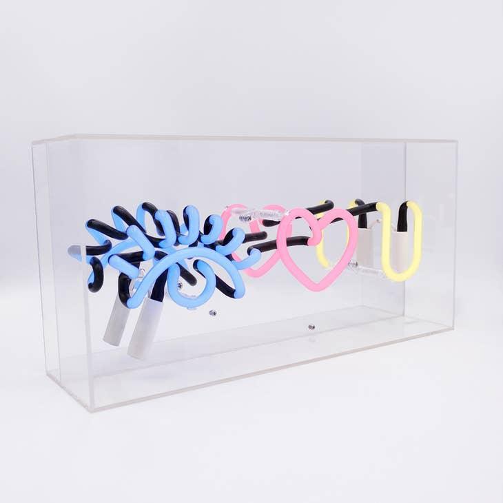 FORMA's Neon "Eye Love You" Lights in blue, red, and yellow, illuminating an affectionate message in a stylish way.