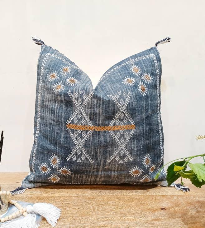 Image showcasing the 'Blue Embroidered Pillow Cover', meticulously crafted from 100% organic cotton and natural fibers, highlighting its intriguing design.