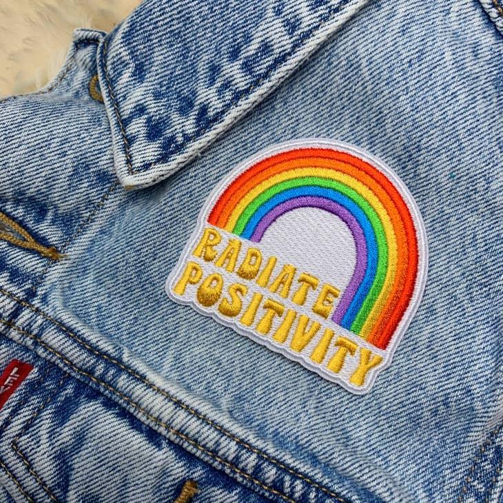 Large vibrant embroidered rainbow patch with "Radiate Positivity" text.