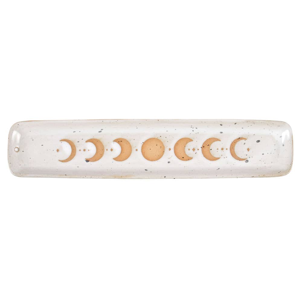 A beautiful stoneware incense holder featuring a moon phase design with a wax resist finish, giving it a handmade feel.
