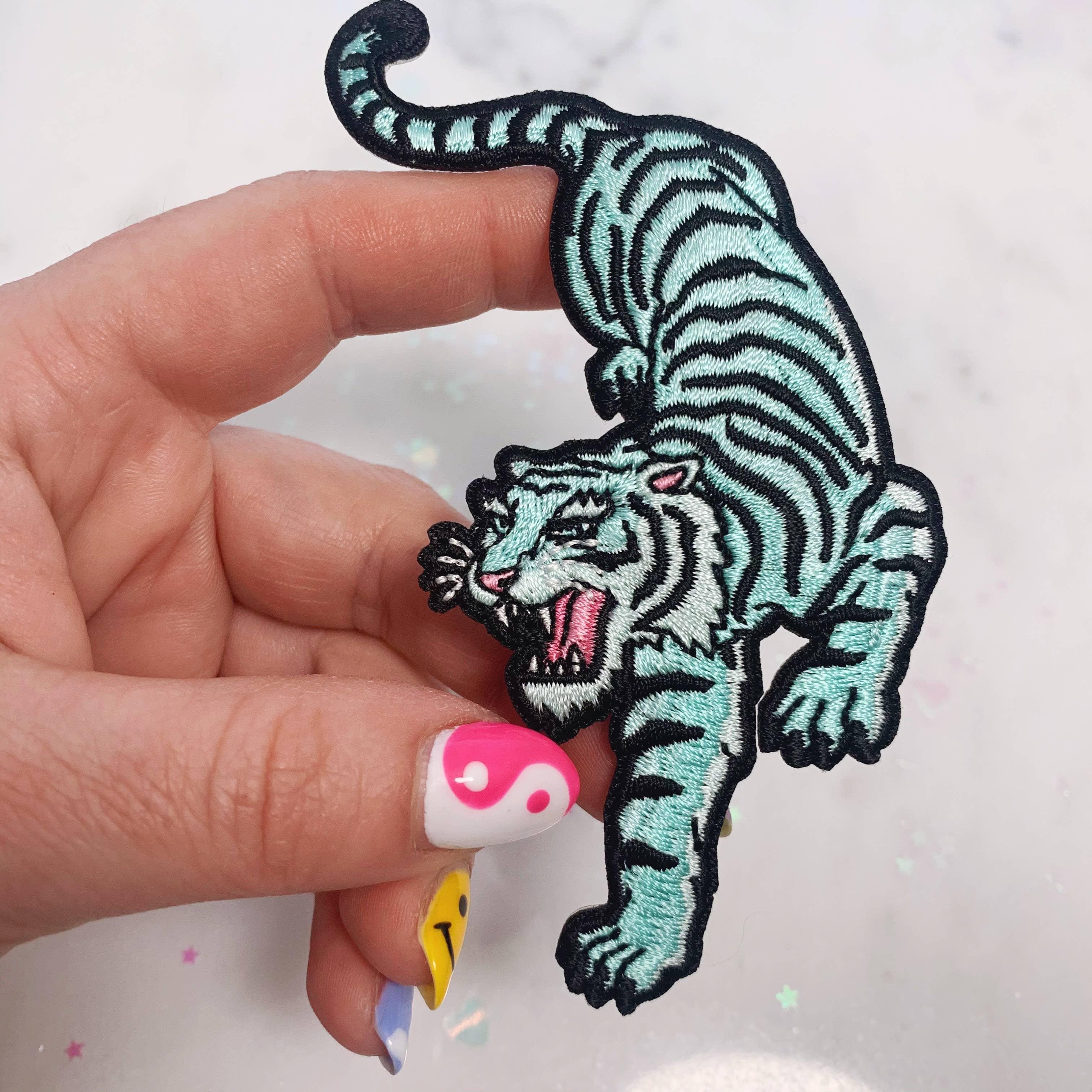Large embroidered patch featuring a fierce green tiger in a poised stance.