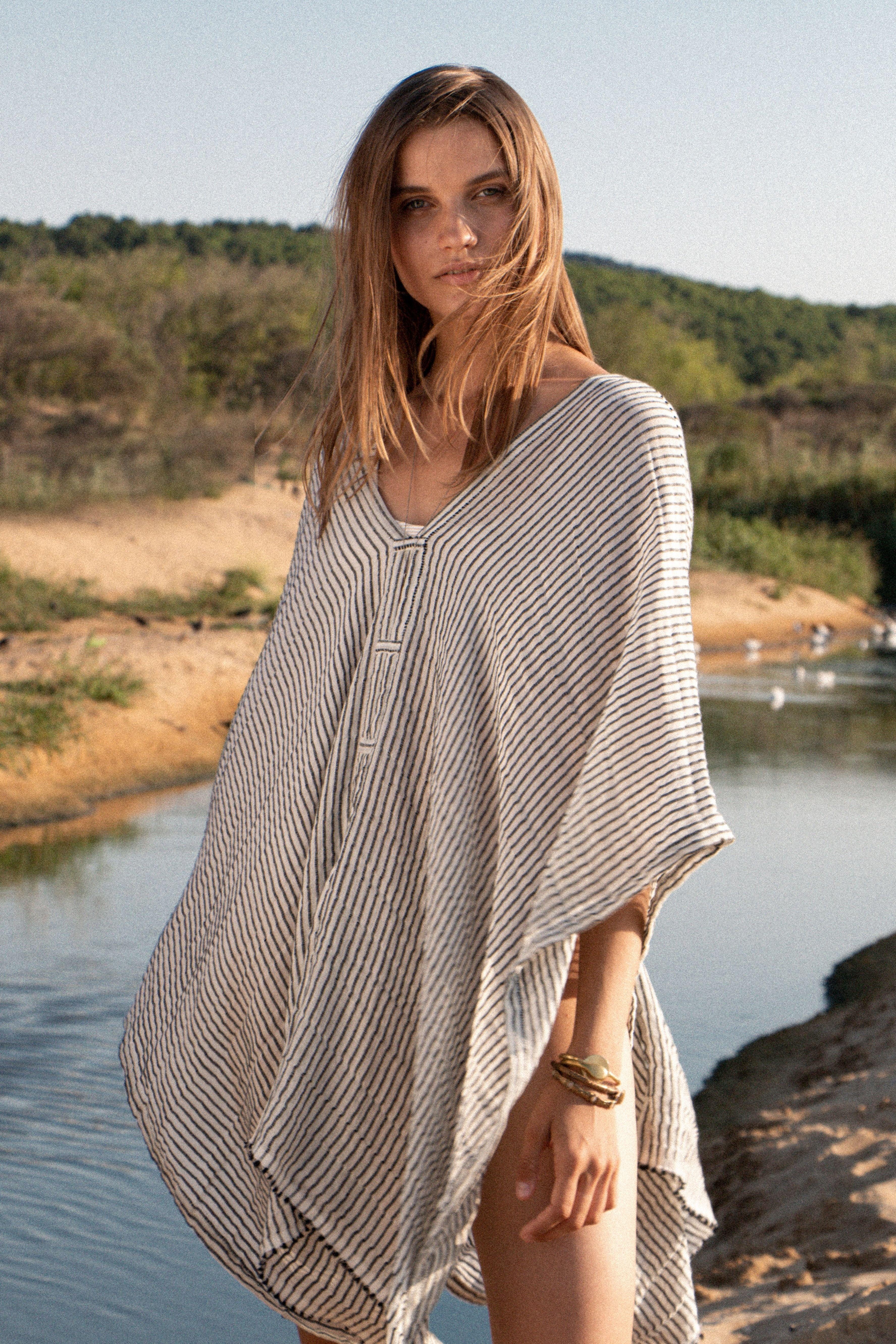 A woman gracefully wearing the Ava Kimono, showcasing its flowing silhouette, delicate patterns, and high-quality fabric.