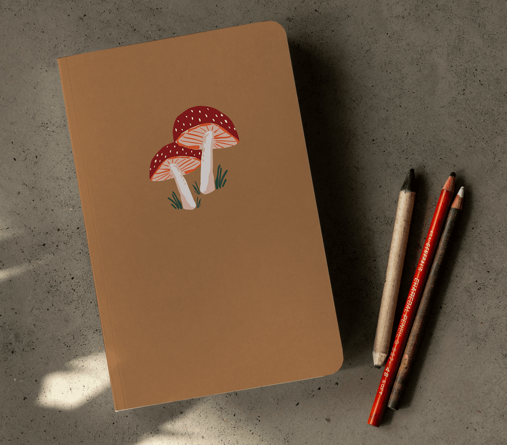 Golden Mushroom Notebook with a sparkling, gold-embossed fungi design on a dark, matte cover.