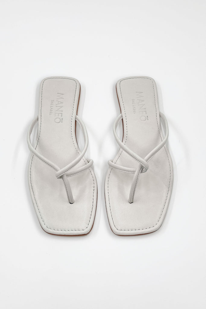 The Marta Sandal displayed against a neutral background, showcasing its stylish flat silhouette.