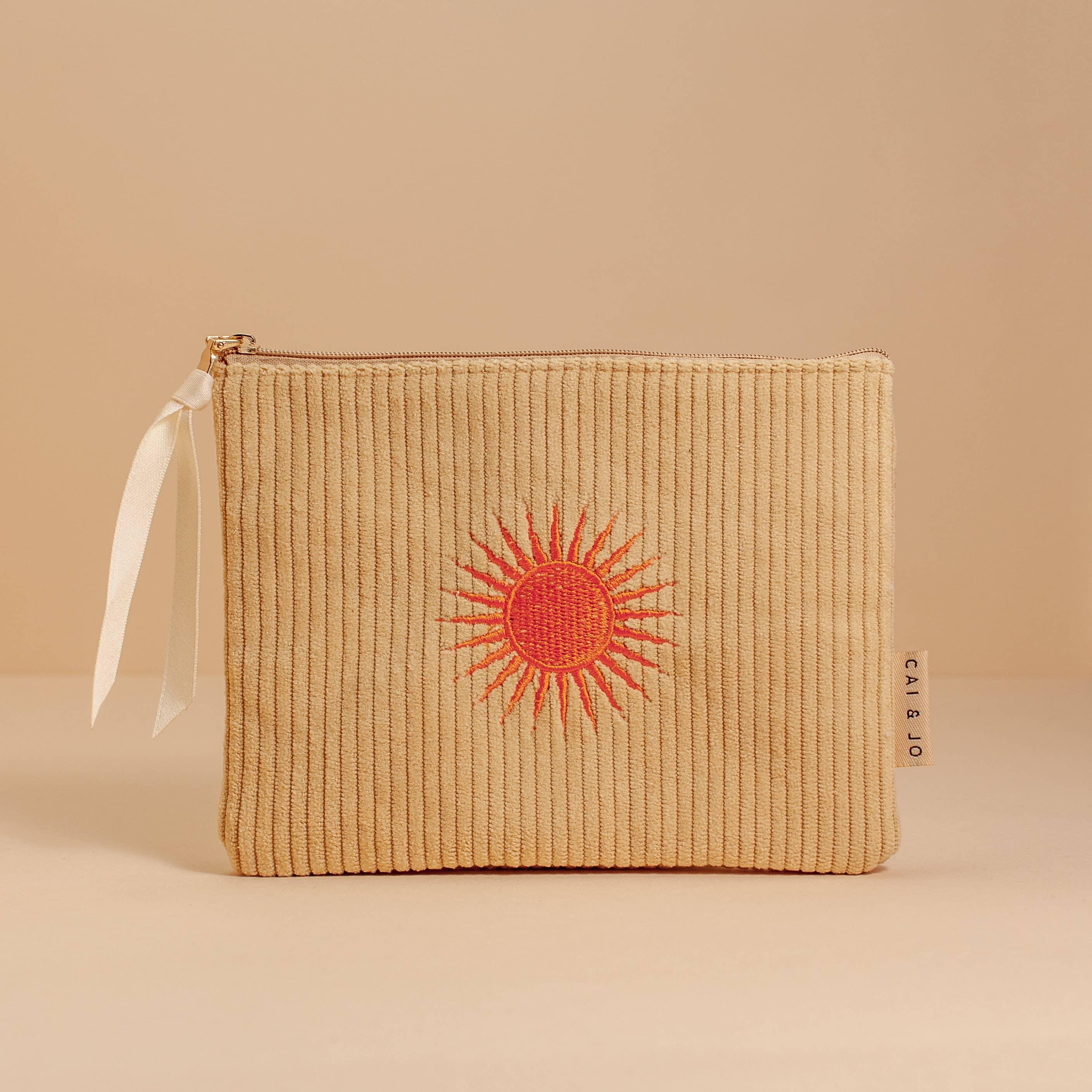 'Solis Corduroy Pouch' crafted from plush corduroy, featuring a sunny motif