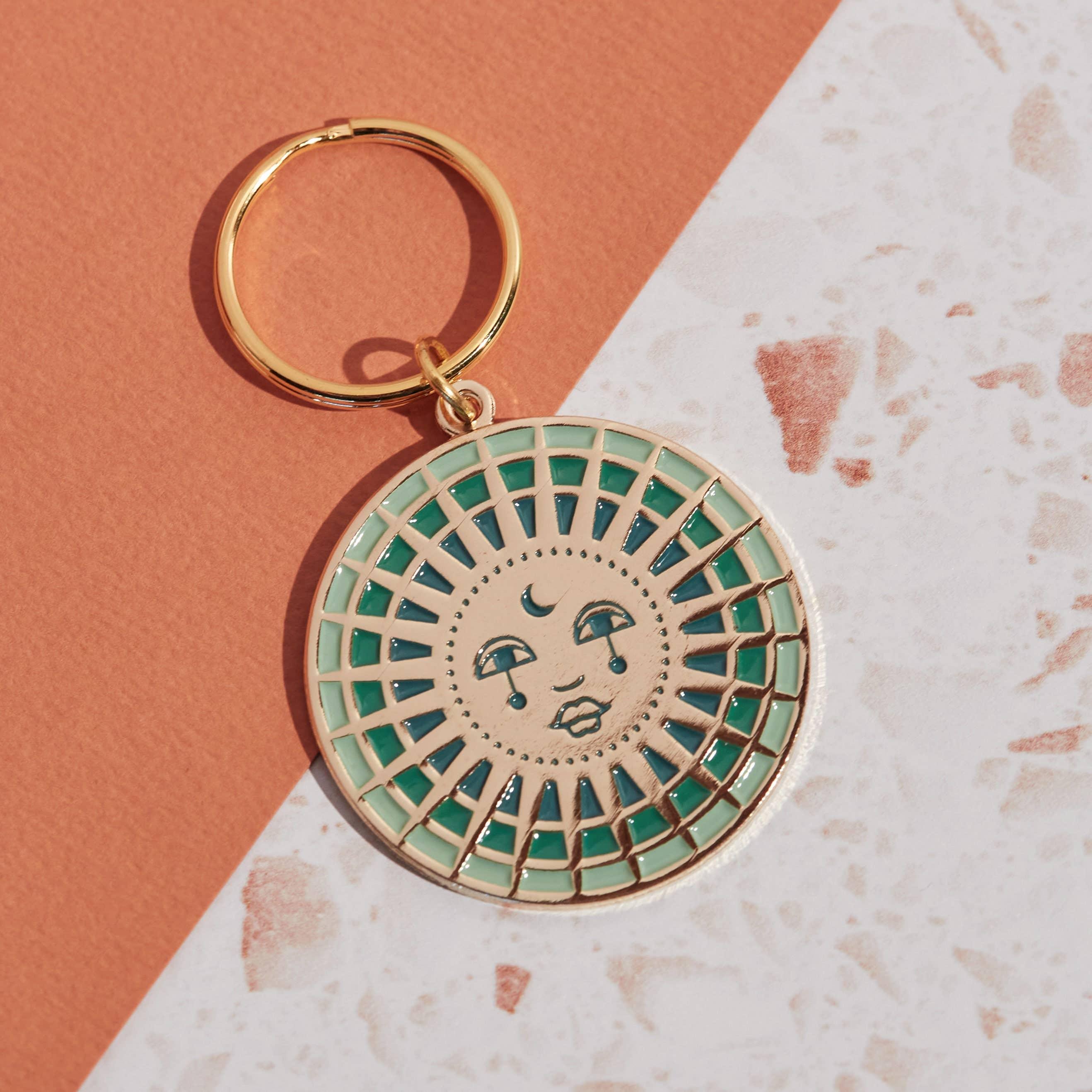 Moon Enamel Keychain featuring a crescent moon design with intricate enamel detailing and a durable metal ring for keys.