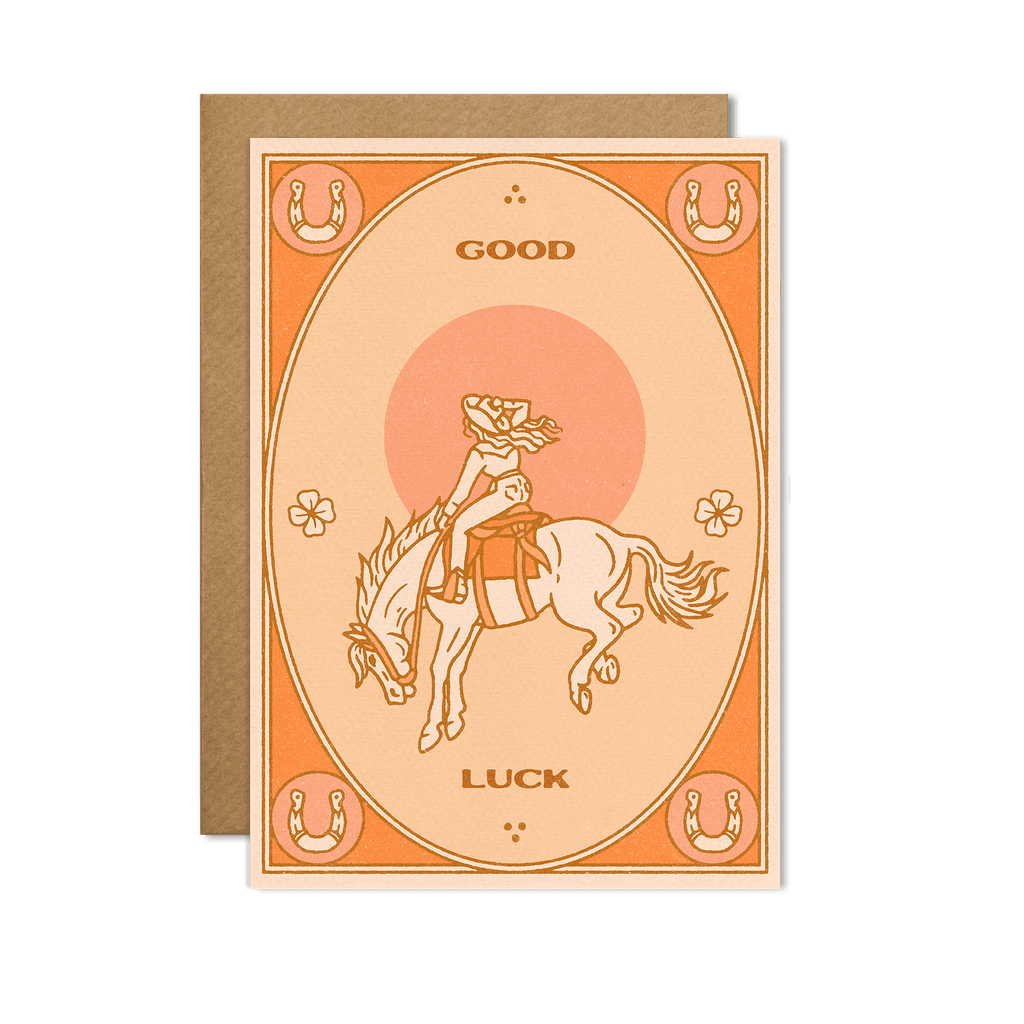  Good Luck Card featuring a lucky charm design on a bright, cheerful background, displayed on a wooden surface.