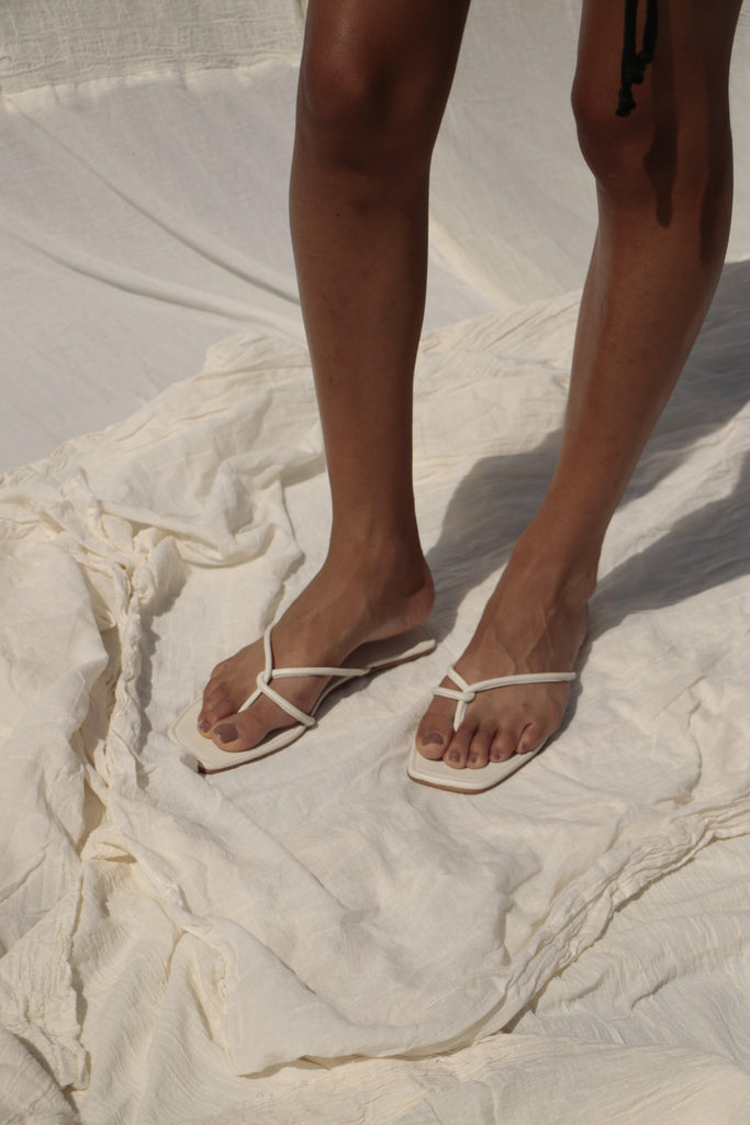 The Marta Sandal displayed against a neutral background, showcasing its stylish flat silhouette.