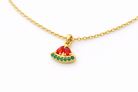 Gold necklace with a watermelon slice pendant on a white background