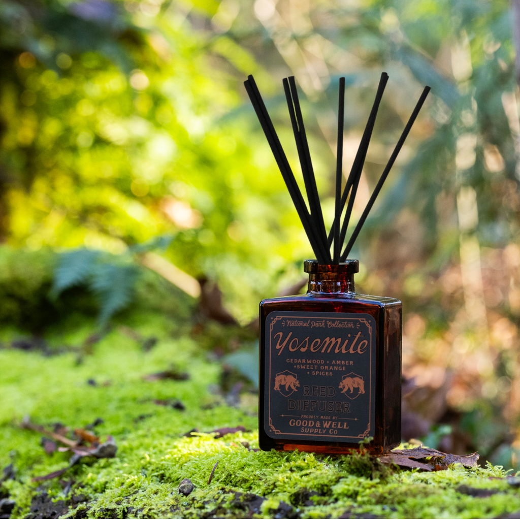 Yosemite reed diffuser with amber glass bottle and black reeds by Good & Well Supply Co., featuring cedarwood, amber, and orange.