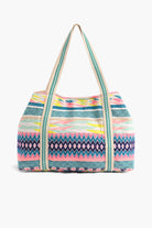 Multicolor embroidered crossbody bag with abstract beading, patterned sides, pom-pom trim, and detachable strap.