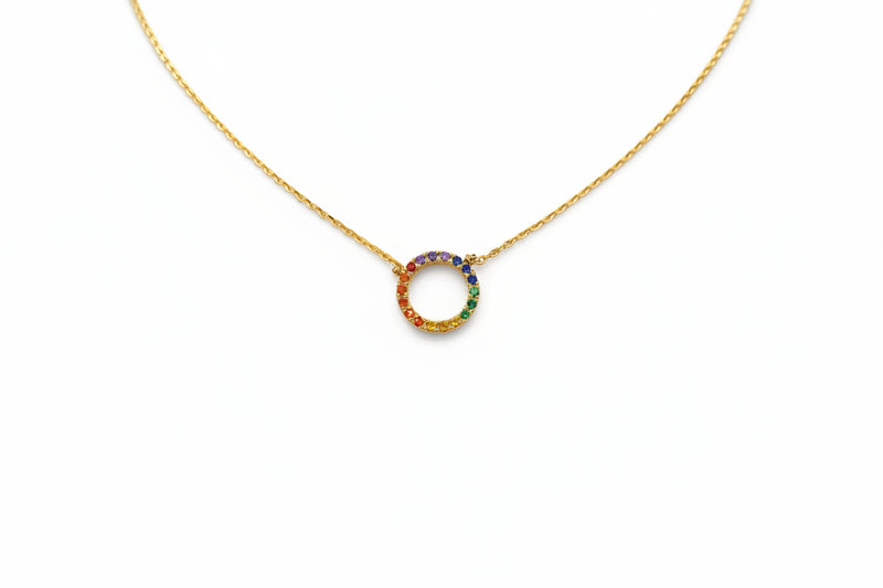 Gold necklace with a colorful circular pendant on a white background