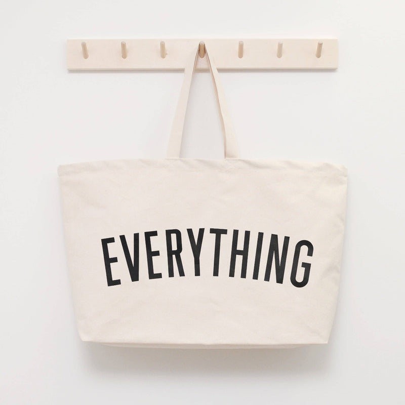 Coral tote bag with “Sunshine Appreciation Society” in white lettering, carried by a woman in a rust-colored embroidered dress
