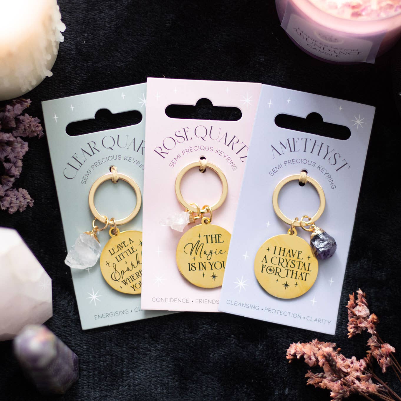 Clear quartz crystal keychain with gold-tone pendant and inspirational message on display card.
