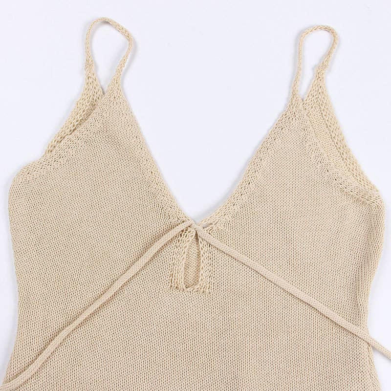 Woman wearing a Seaside Serenity Crochet Cover-Up Dress with a crochet design, adjustable spaghetti straps, and a fringe hem.