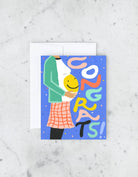 Greeting card with colorful “Congrats!” text and illustration of a pregnant belly with a smiley face.
