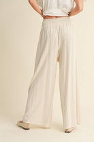 Wide-leg cotton-linen pants with smocked waistband and tassel drawstring