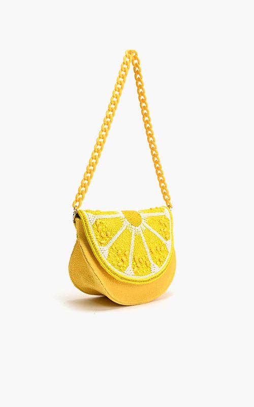 Yellow lemon slice-shaped bag with beaded detailing and a matching twisted rope shoulder strap.