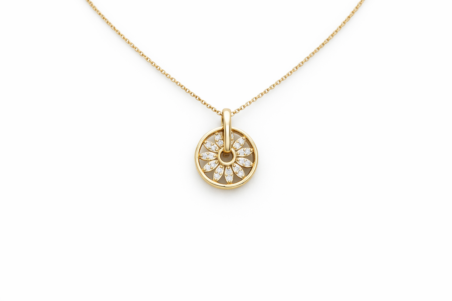 Gold necklace with a round pendant on a white background